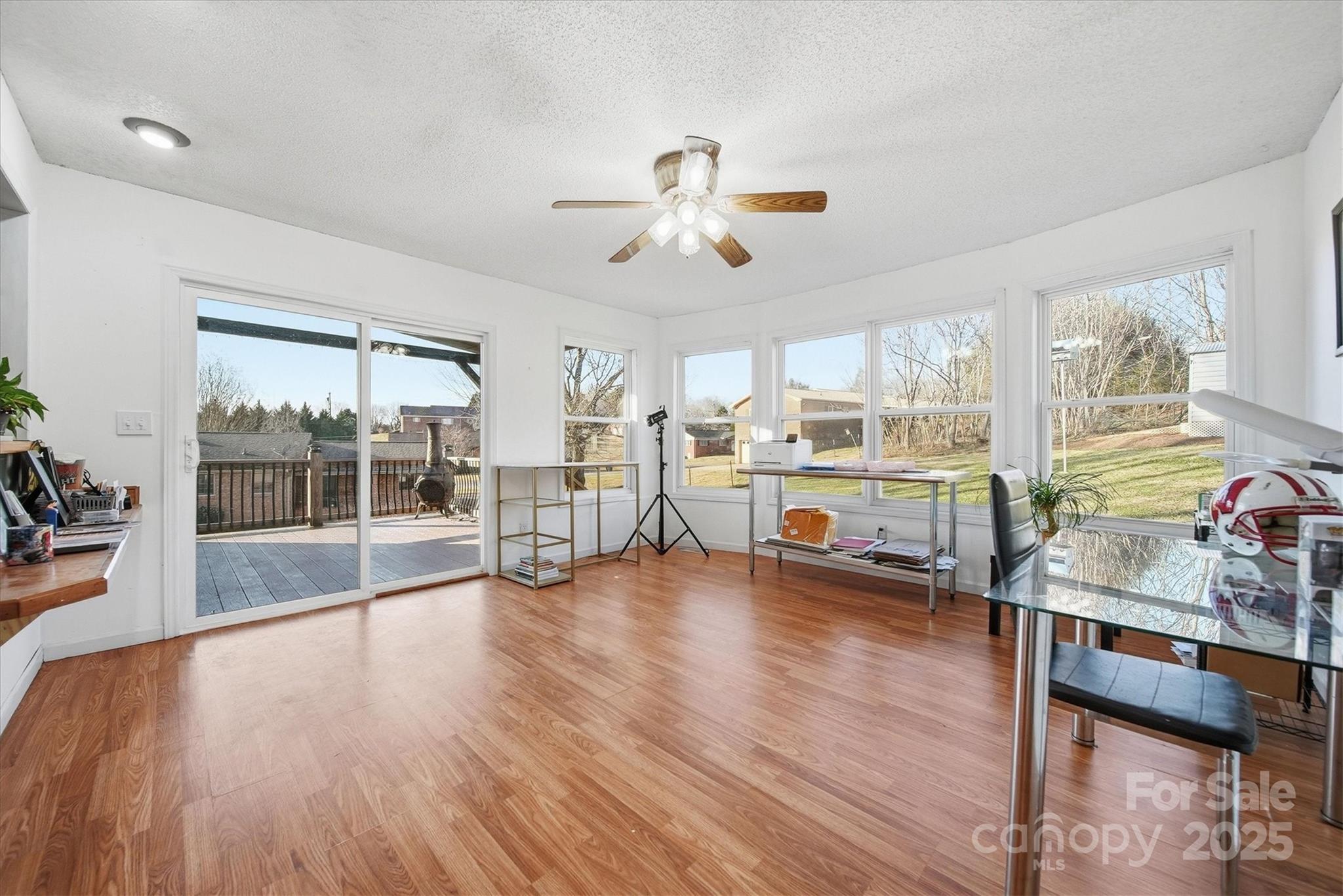 1007 Millbrook Place Southeast Lenoir, NC 28645 - Photo 19 of 46 a view of a livingroom with furniture wooden floor and a ceiling fan