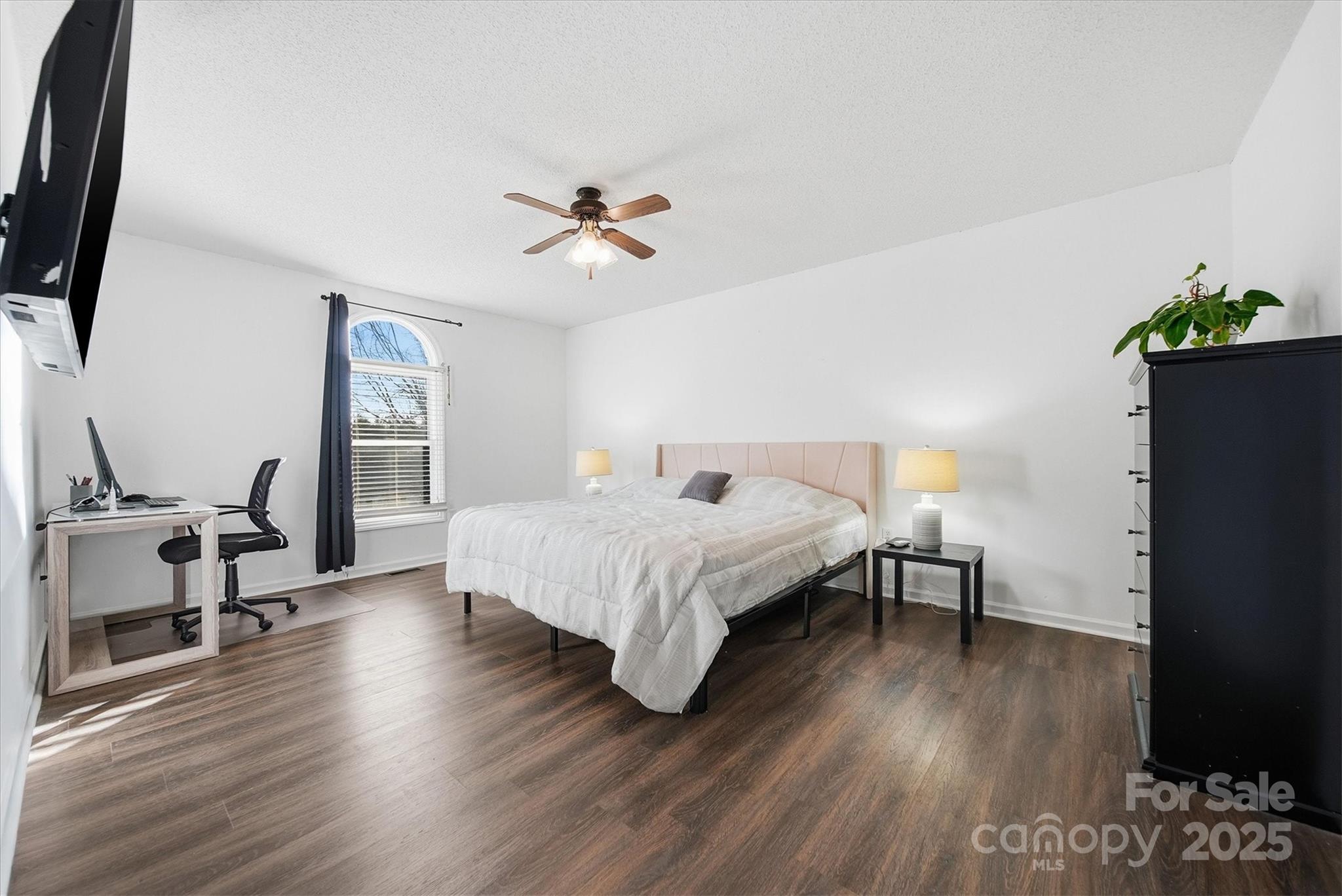 1007 Millbrook Place Southeast Lenoir, NC 28645 - Photo 23 of 46 a spacious bedroom with a bed a dresser and wooden floor