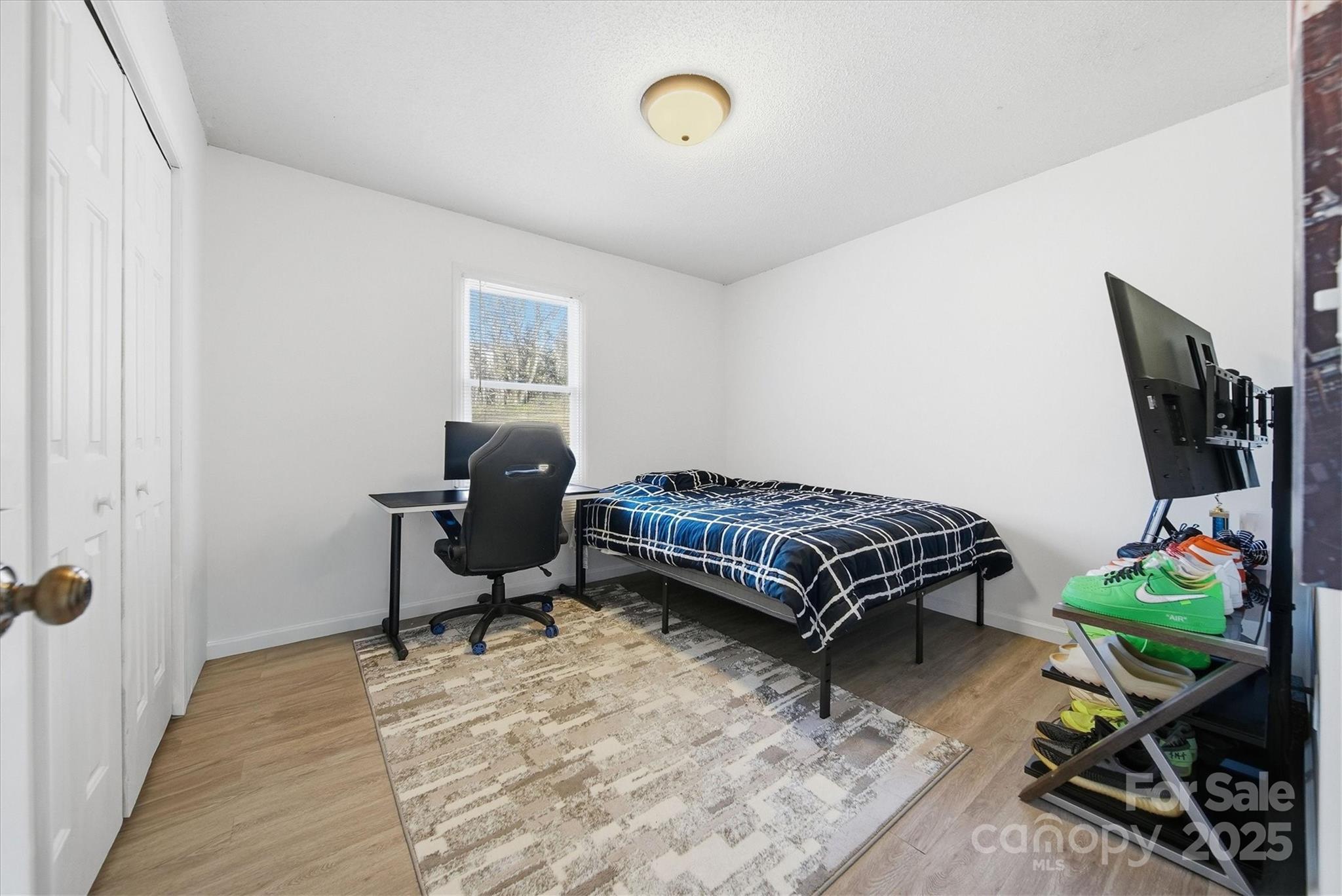 1007 Millbrook Place Southeast Lenoir, NC 28645 - Photo 30 of 46 a bedroom with a bed table chair and a window