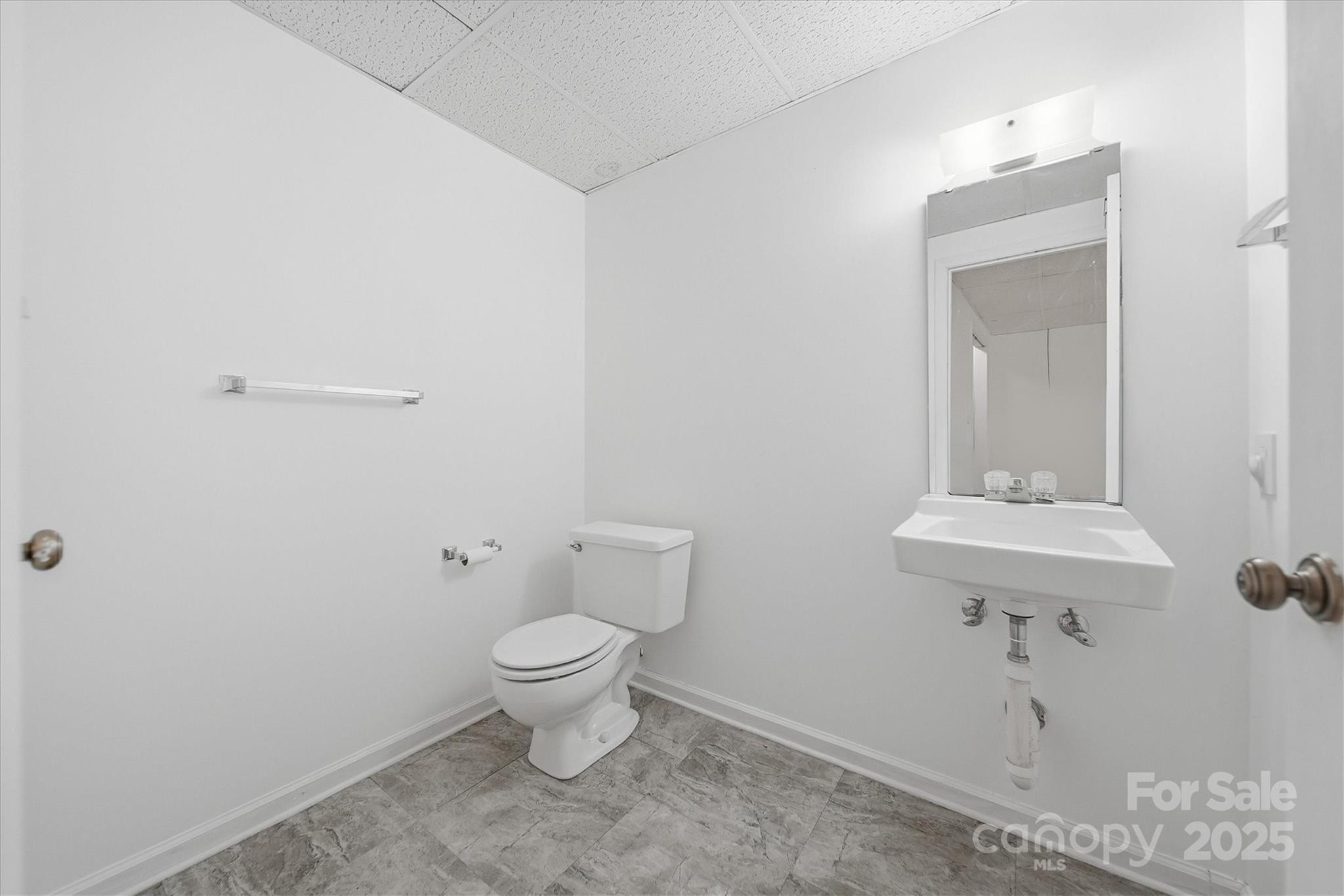 1007 Millbrook Place Southeast Lenoir, NC 28645 - Photo 34 of 46 a bathroom with a sink a toilet and mirror