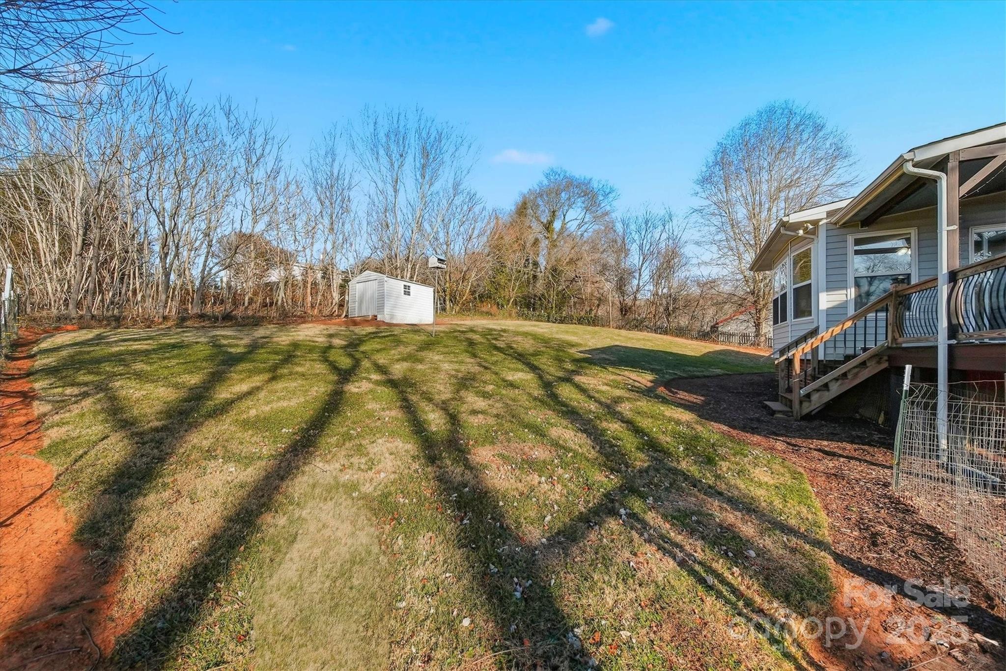 1007 Millbrook Place Southeast Lenoir, NC 28645 - Photo 37 of 46 a view of swimming pool of water with lawn chairs and wooden fence