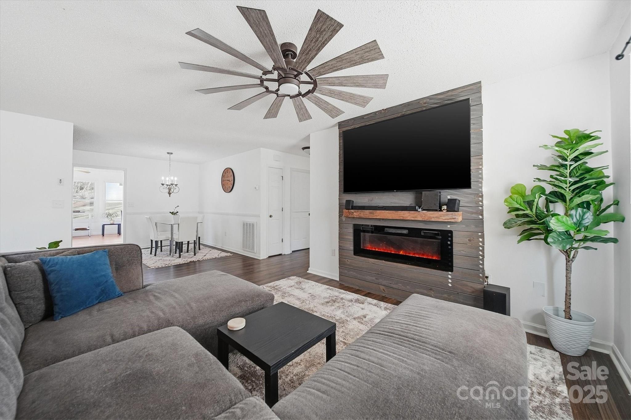 1007 Millbrook Place Southeast Lenoir, NC 28645 - Photo 7 of 46 a living room with furniture a fireplace and a flat screen tv