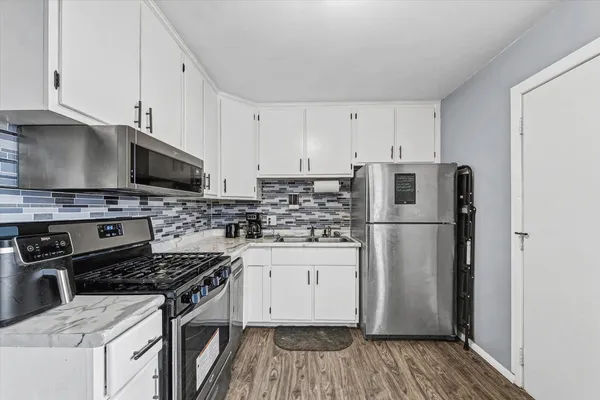 a kitchen with a sink a stove and refrigerator