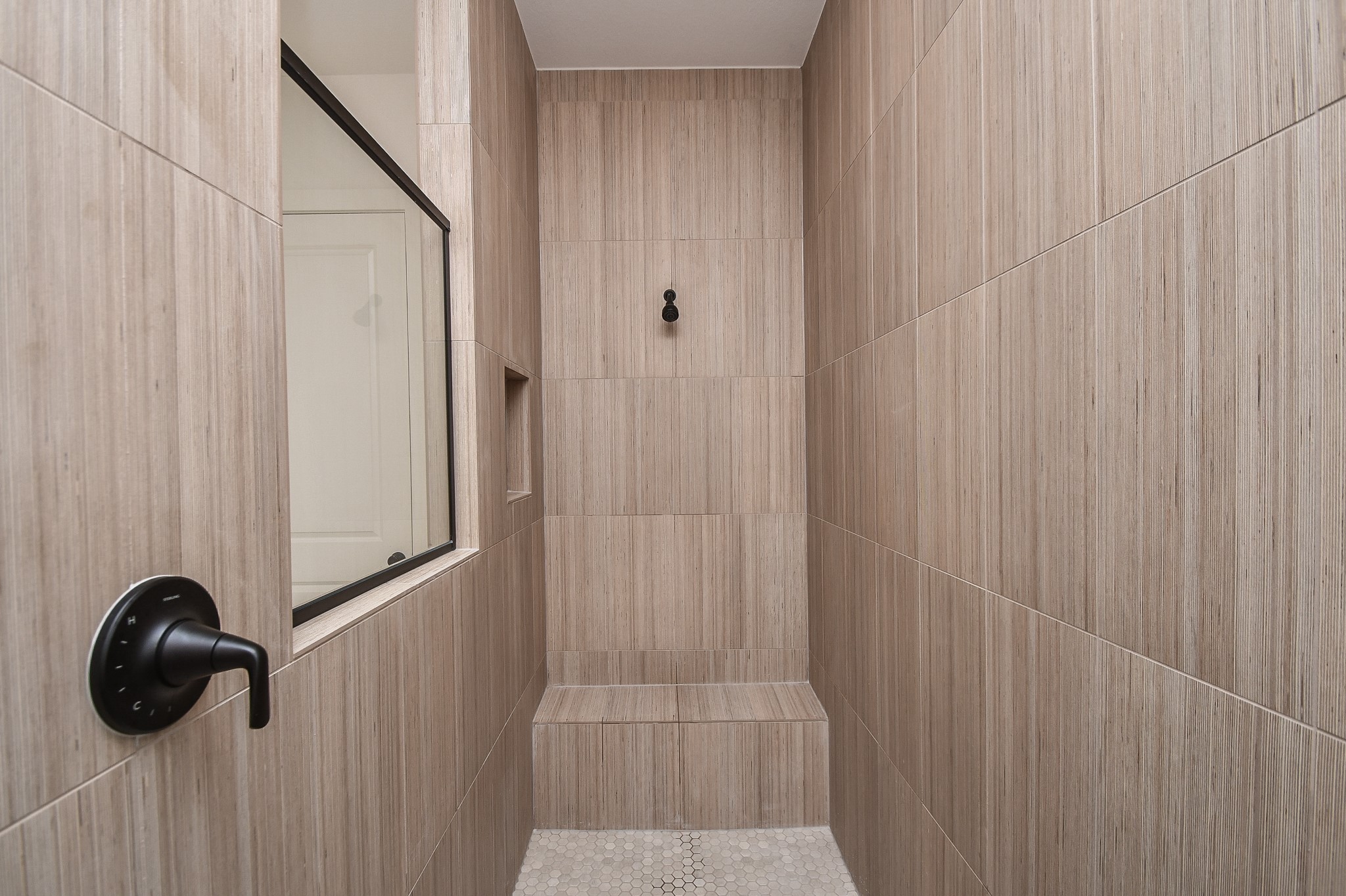 31915 Sky Rdg Lane Fulshear, TX 77441 - Photo 29 of 38 Experience luxury and tranquility in this elegant primary bathroom, featuring a sleek, modern extended shower with chic tile design and contemporary fixtures.