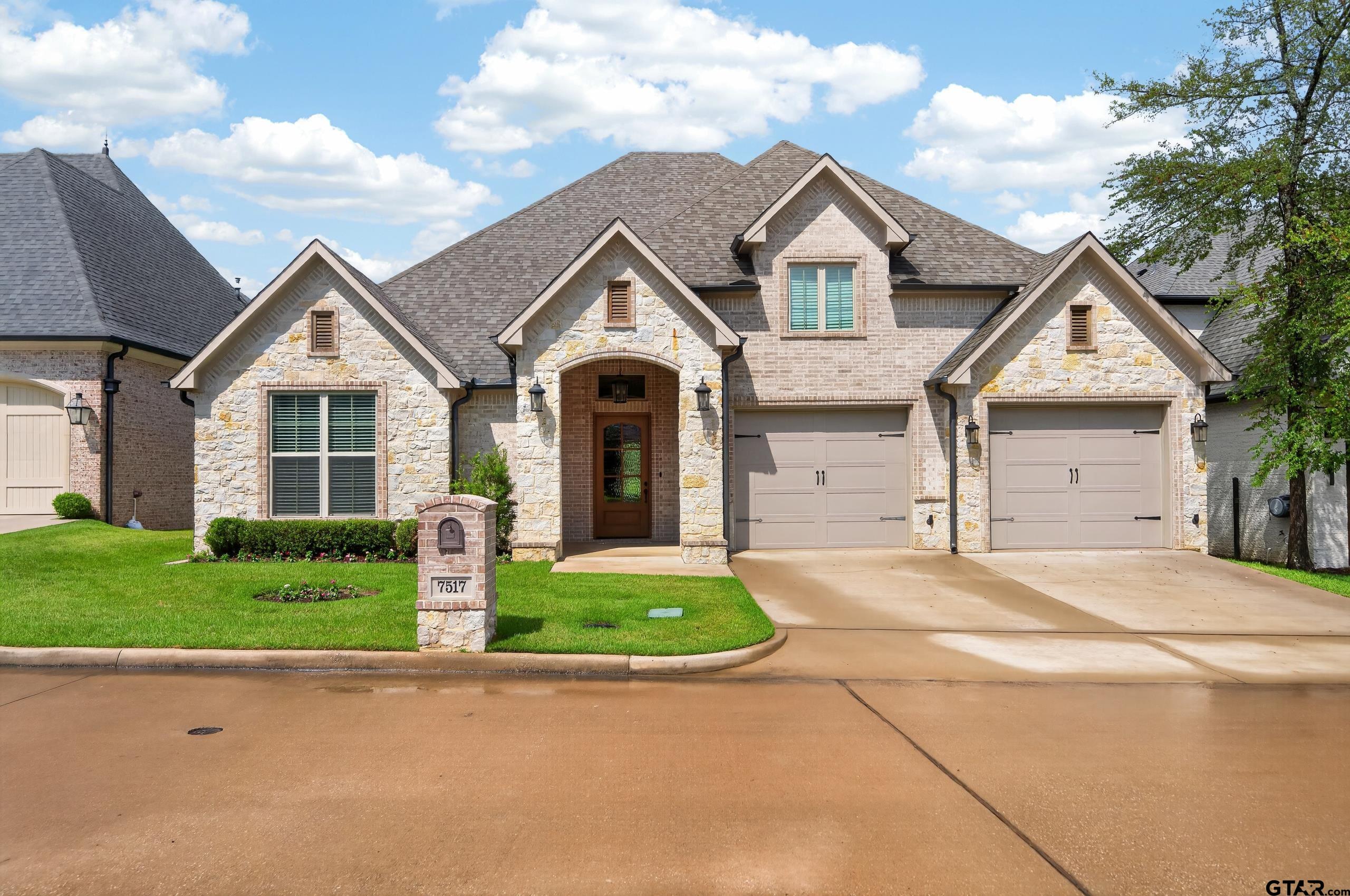 7517 Cross Gate Way Tyler, TX 75703 - Photo 29 of 47 a front view of a house with a yard and garage