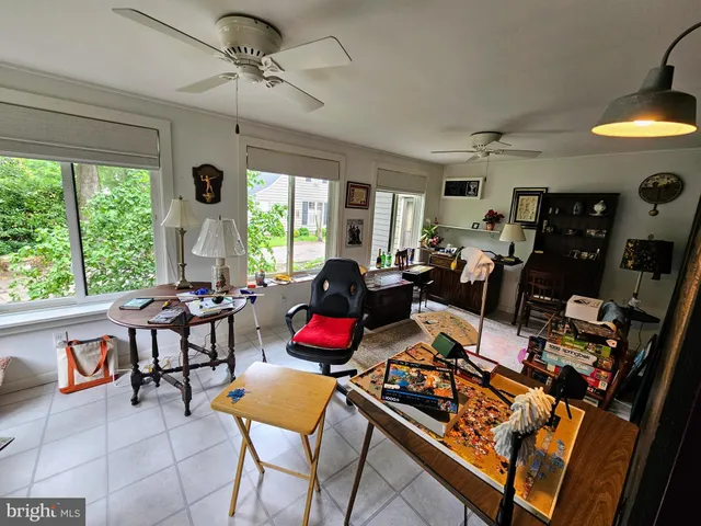 a living room with furniture a fireplace and a large window