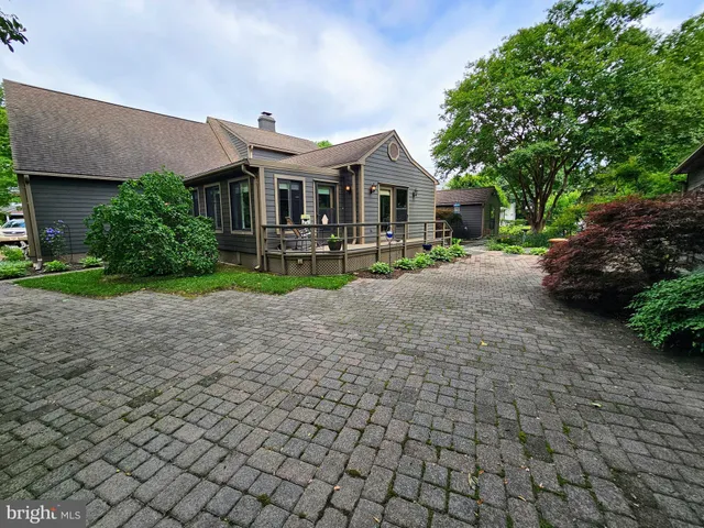 a front view of a house with yard and a garden