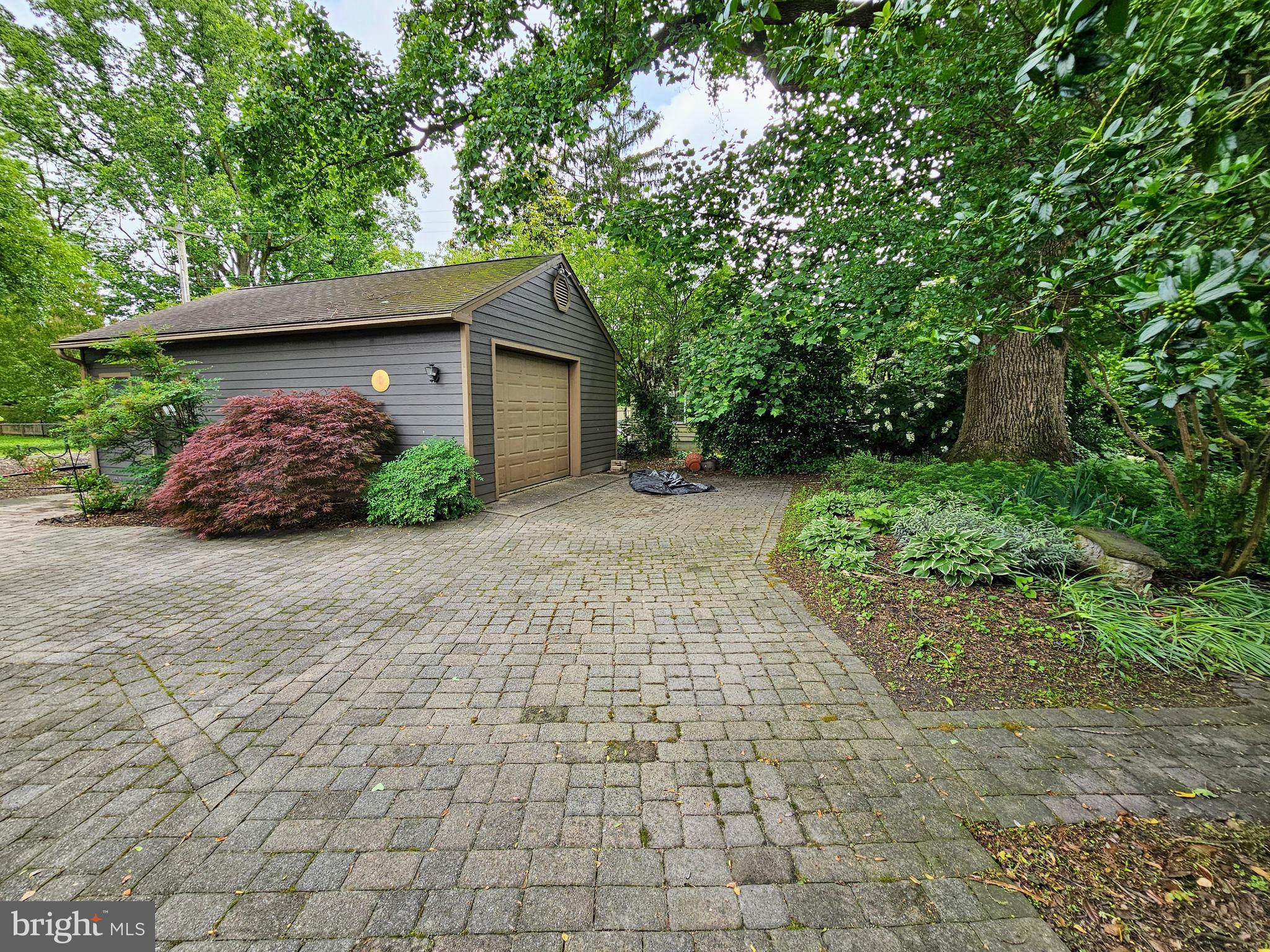 35 Read Street Seaford, DE 19973 - Photo 8 of 21 a pathway of a house with potted plants and large trees