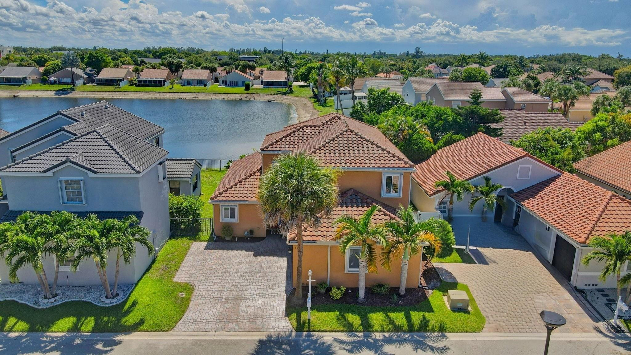 22271 Festival Way Boca Raton, FL 33428 - Photo 1 of 62 an aerial view of a house with a yard and a garden