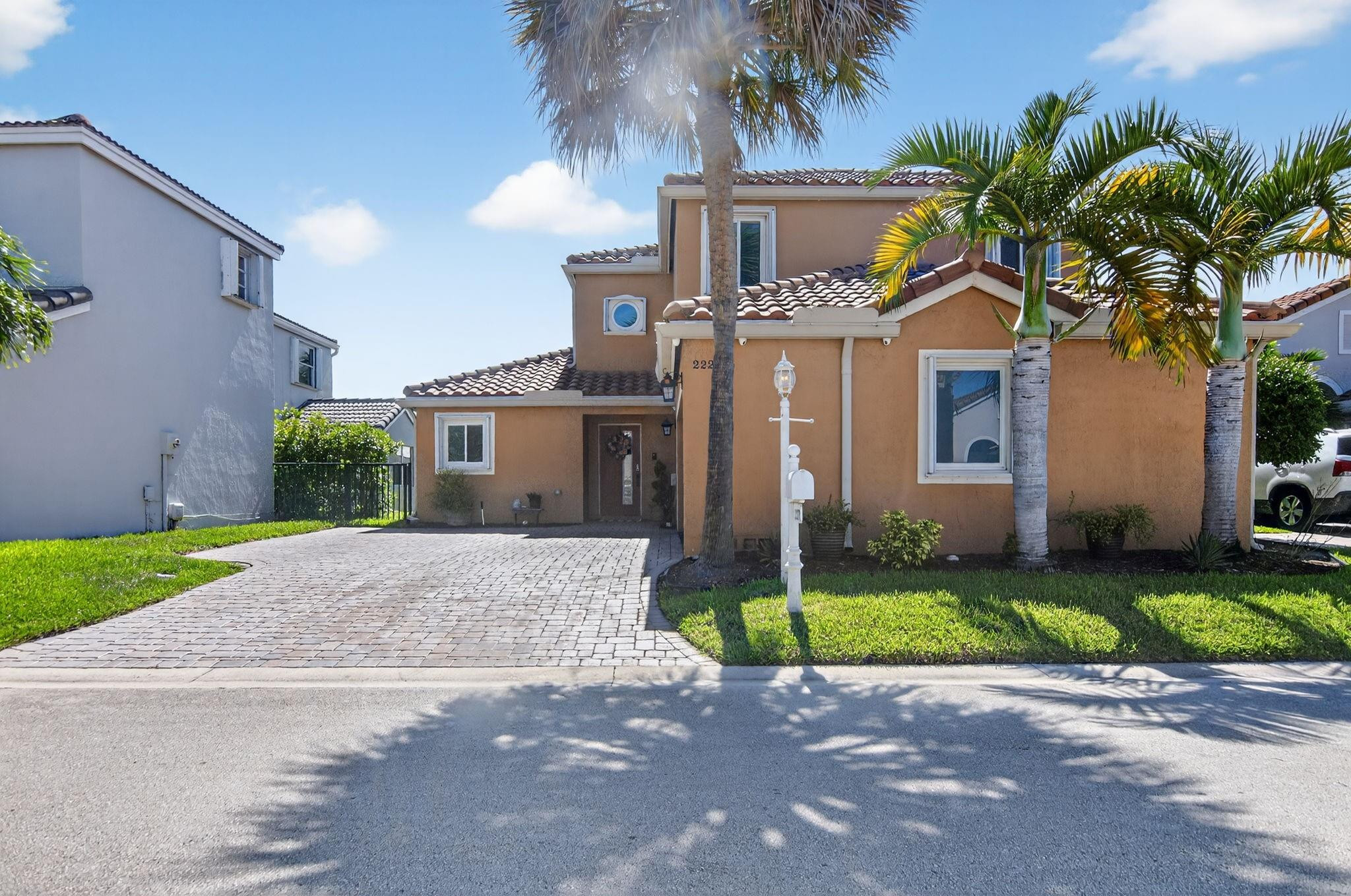 22271 Festival Way Boca Raton, FL 33428 - Photo 3 of 62 a front view of a house with a yard and garage