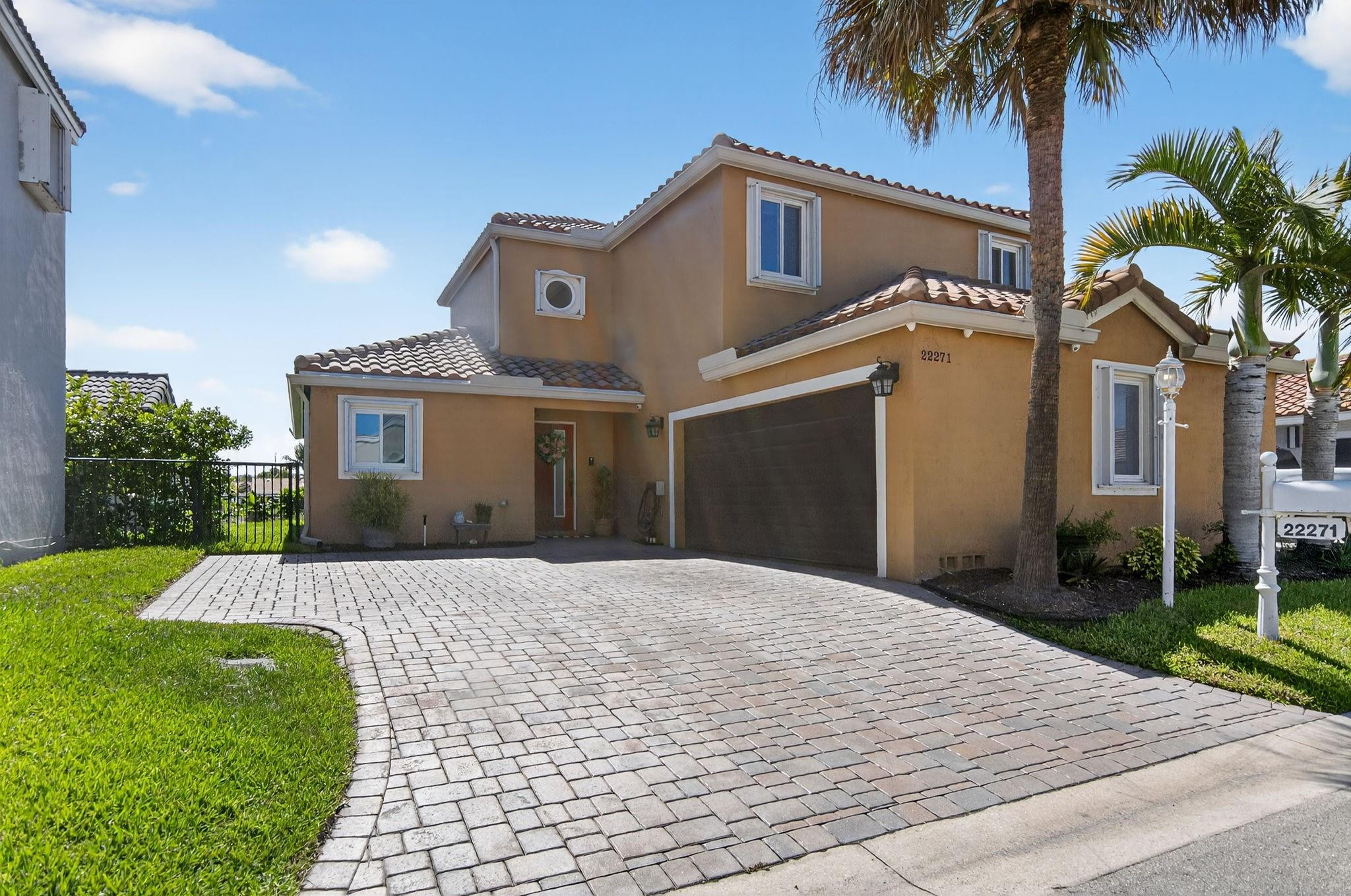22271 Festival Way Boca Raton, FL 33428 - Photo 4 of 62 a front view of a house with a yard and garage