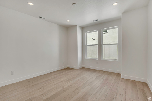 10999 South Freestone Road, Unit 111 South Jordan, UT 84009 - Photo 4 of 13 Empty room with light wood finished floors and recessed lighting