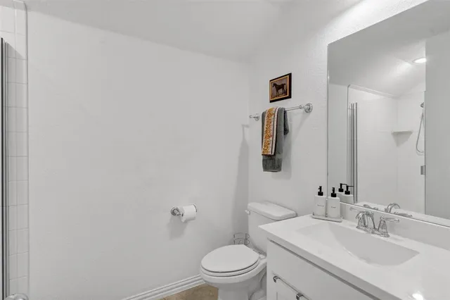 a bathroom with a sink a toilet and mirror