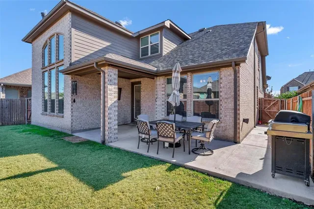 a view of a house with backyard porch and sitting area