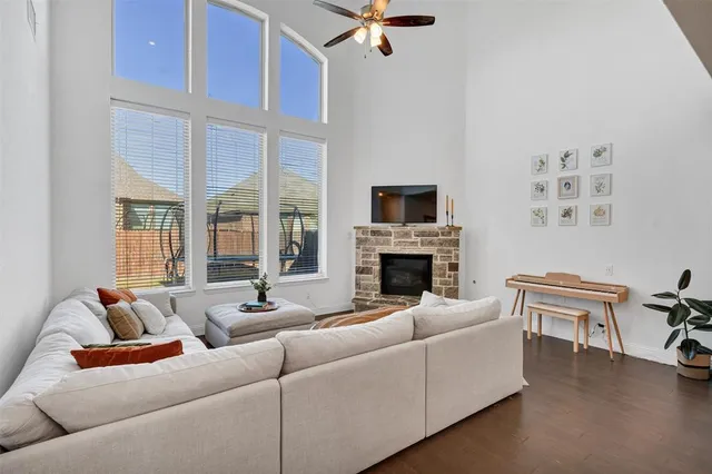 a living room with furniture a fireplace and a flat screen tv