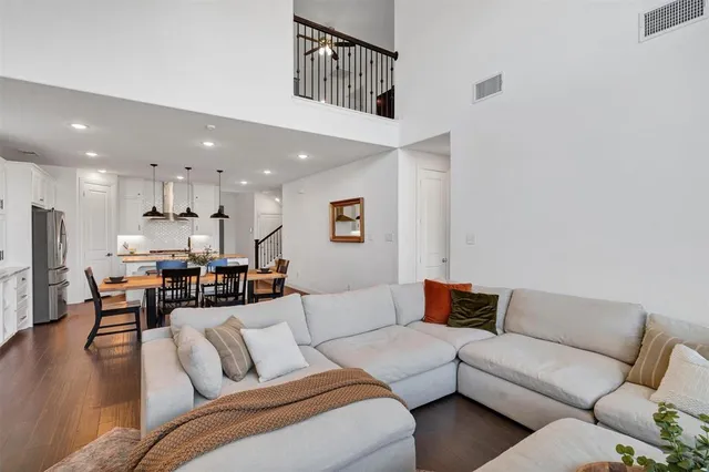 a living room with furniture kitchen view and a dining table