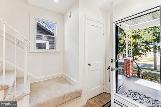 a view of entryway with wooden floor and door