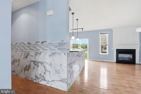 a view of kitchen with furniture and wooden floor