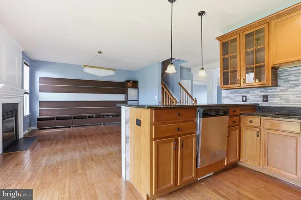 a kitchen view with wooden floor and a sink