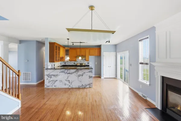 a view of kitchen with cabinets and wooden floor