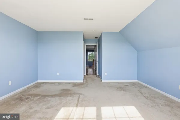 a view of an empty room with closet