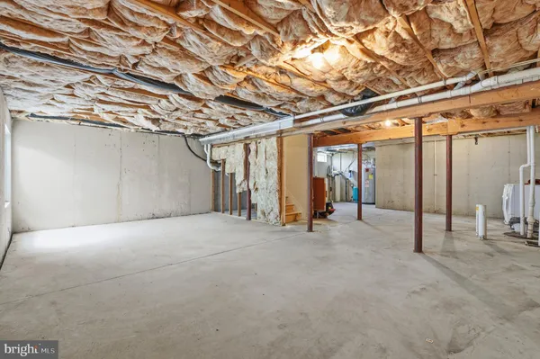 a view of empty room with wooden walls