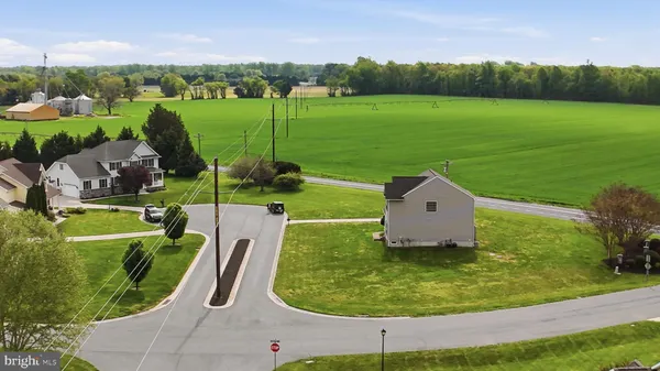 an aerial view of a house with a garden and trees