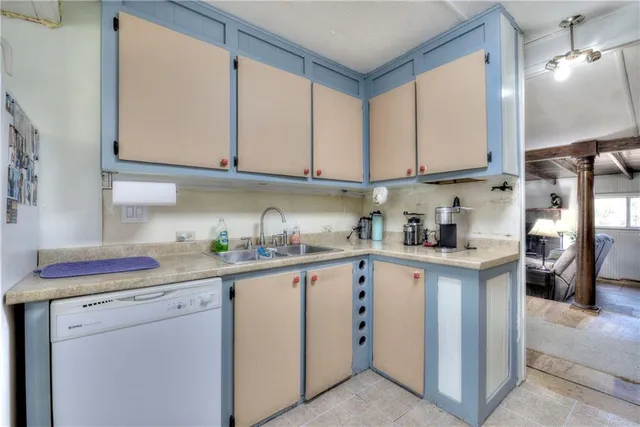 a kitchen with cabinets and window