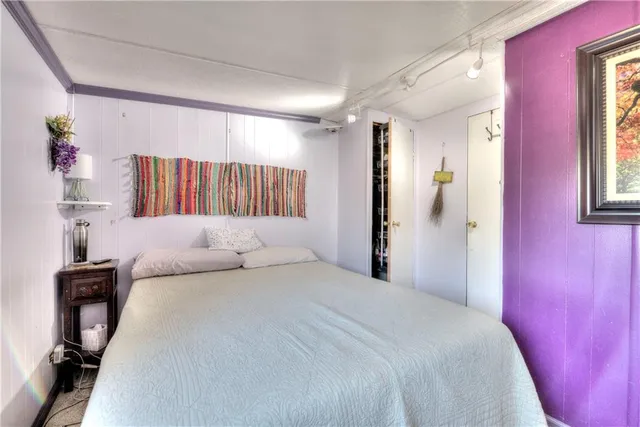 a bedroom with a bed and window