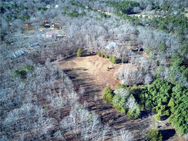 a view of a dry field with trees