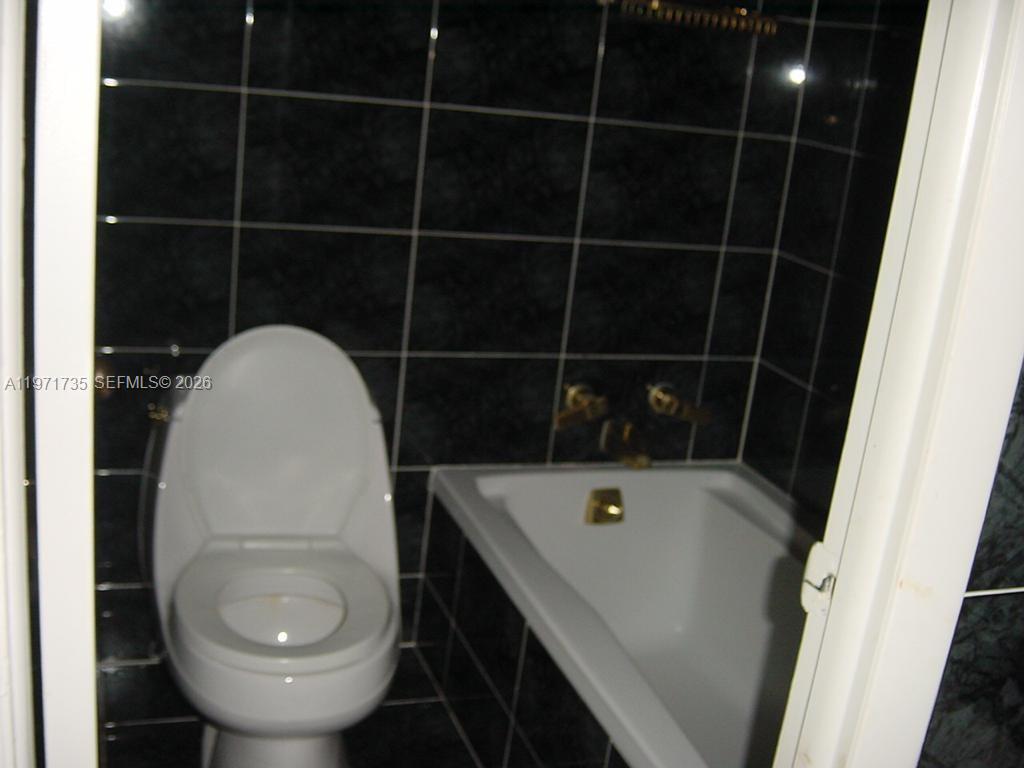 1450 Lincoln Road, Unit 604 Miami Beach, FL 33139 - Photo 13 of 16 a bathroom with a sink and toilet