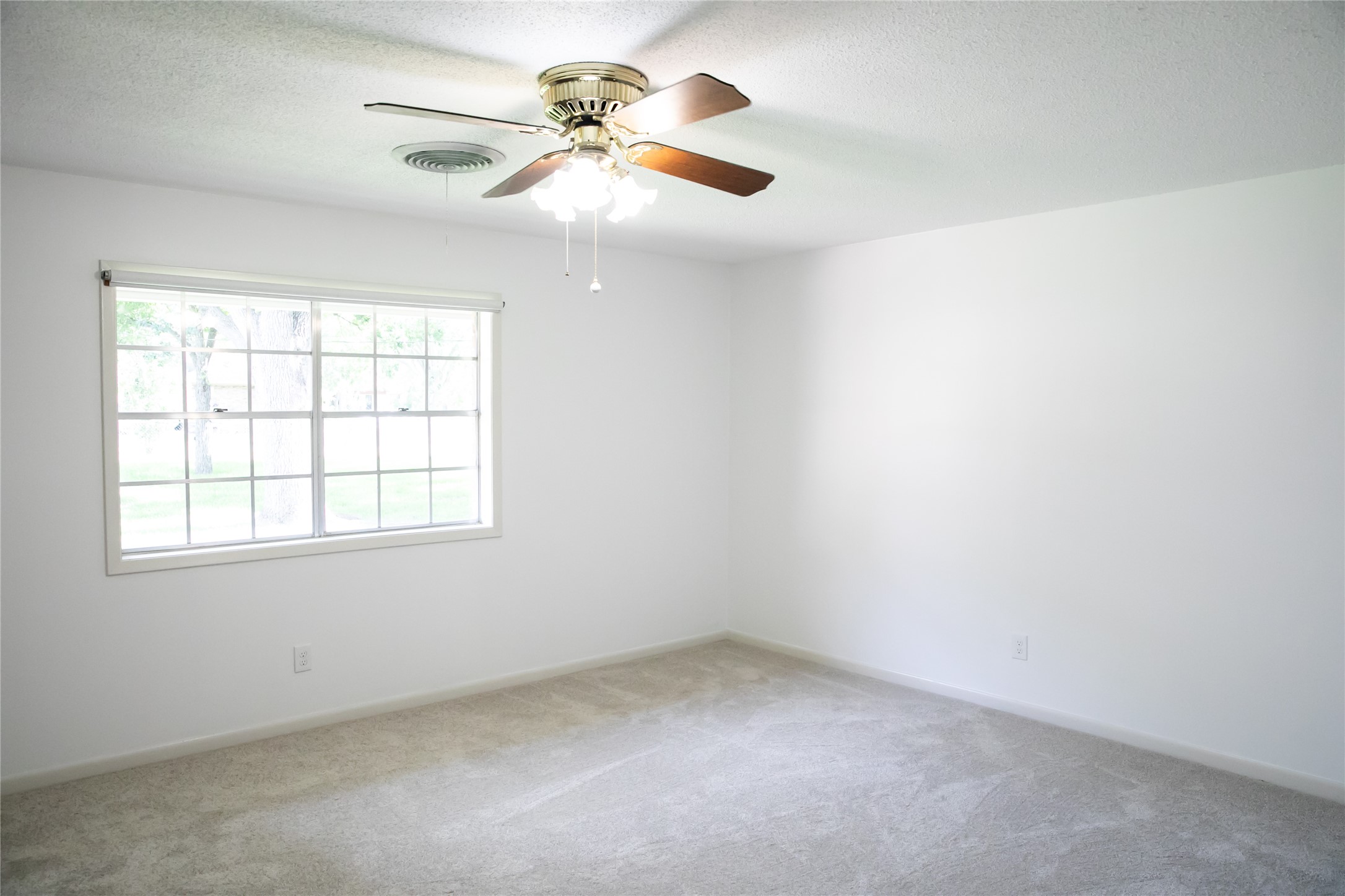 1600 Reimer Street Brenham, TX 77833 - Photo 17 of 24 an empty room with a window and a fan