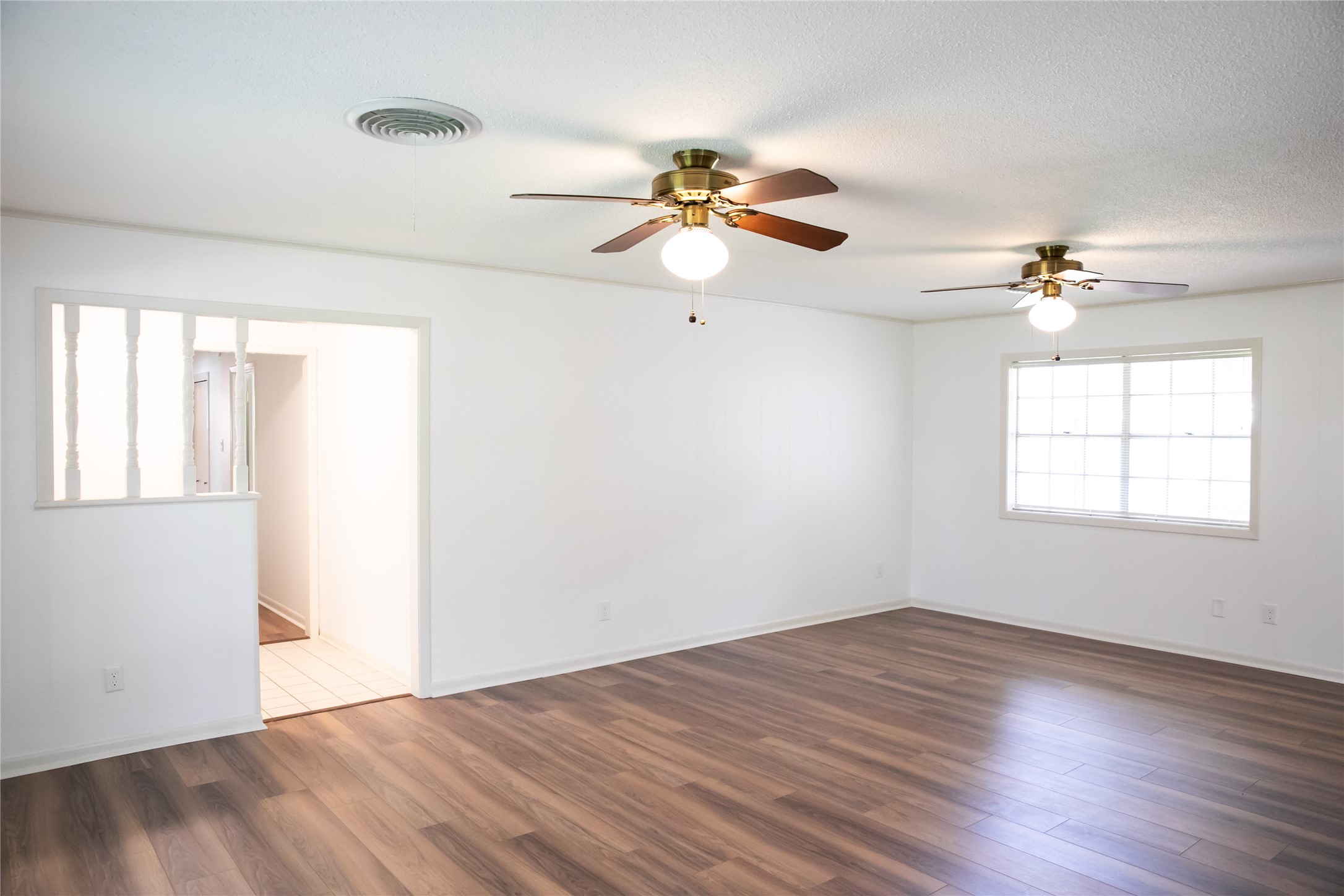1600 Reimer Street Brenham, TX 77833 - Photo 9 of 24 wooden floor in an empty room with a window