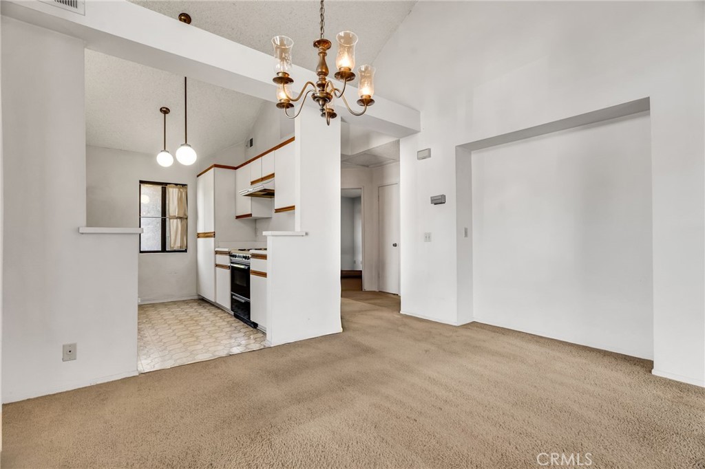 320 North Montebello Boulevard Montebello, CA 90640 - Photo 4 of 15 a view of a kitchen with a refrigerator and a chandelier