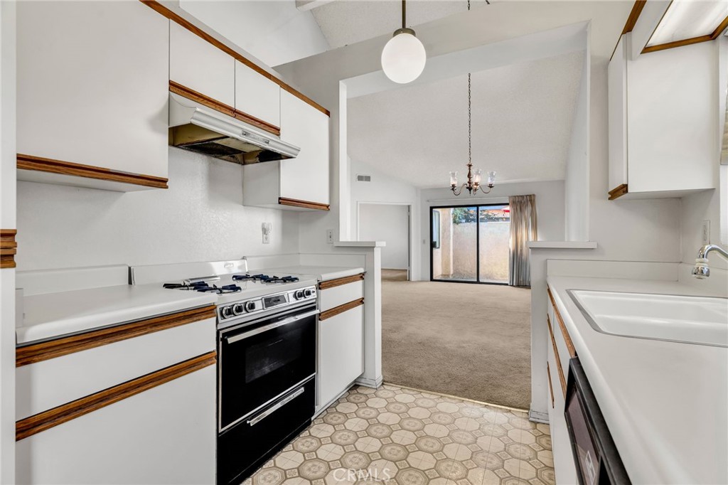 320 North Montebello Boulevard Montebello, CA 90640 - Photo 5 of 15 a kitchen with a stove sink and cabinets