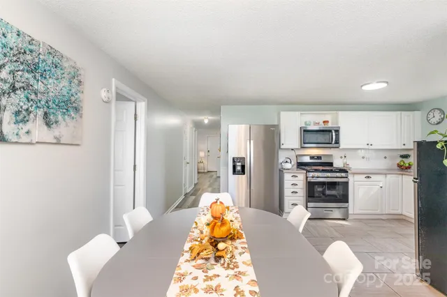 a kitchen with stainless steel appliances a refrigerator and a stove top oven