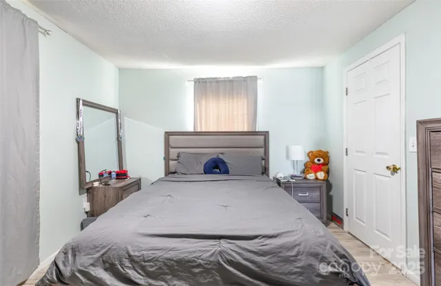 a bedroom with a bed and a fireplace