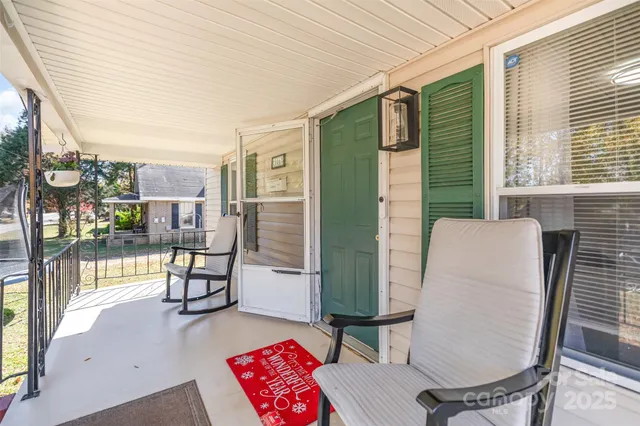 a balcony with table and chairs