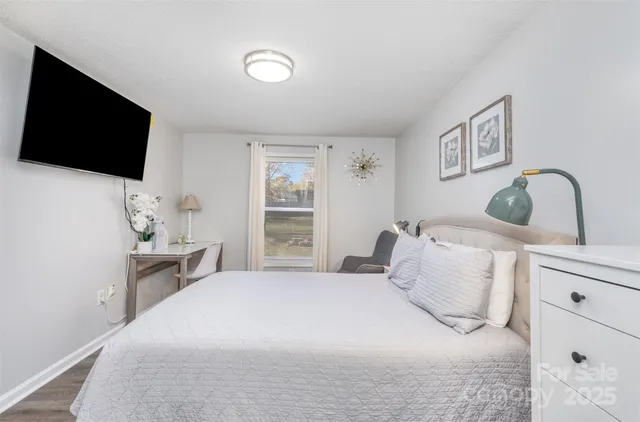 a bedroom with a bed and a flat screen tv