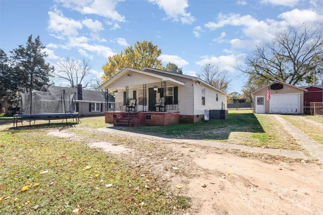 a view of a house with a yard covered with snow
