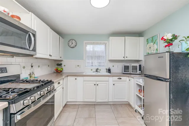 a kitchen with cabinets and stainless steel appliances
