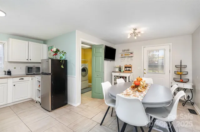 a kitchen with stainless steel appliances kitchen island granite countertop a refrigerator and a stove top oven