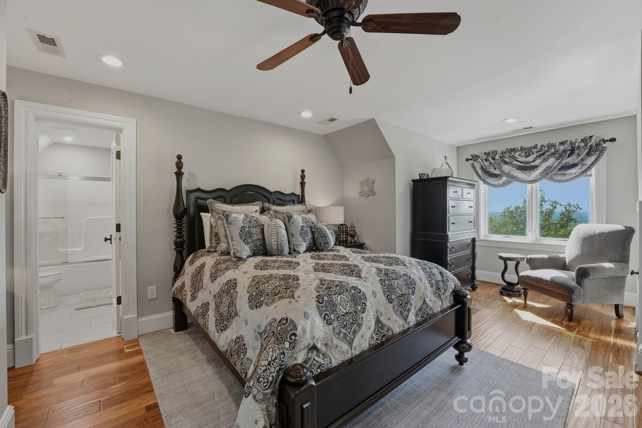 605 Recore Rdg Road Bessemer City, NC 28016 - Photo 21 of 47 a bedroom with a bed and a chandelier