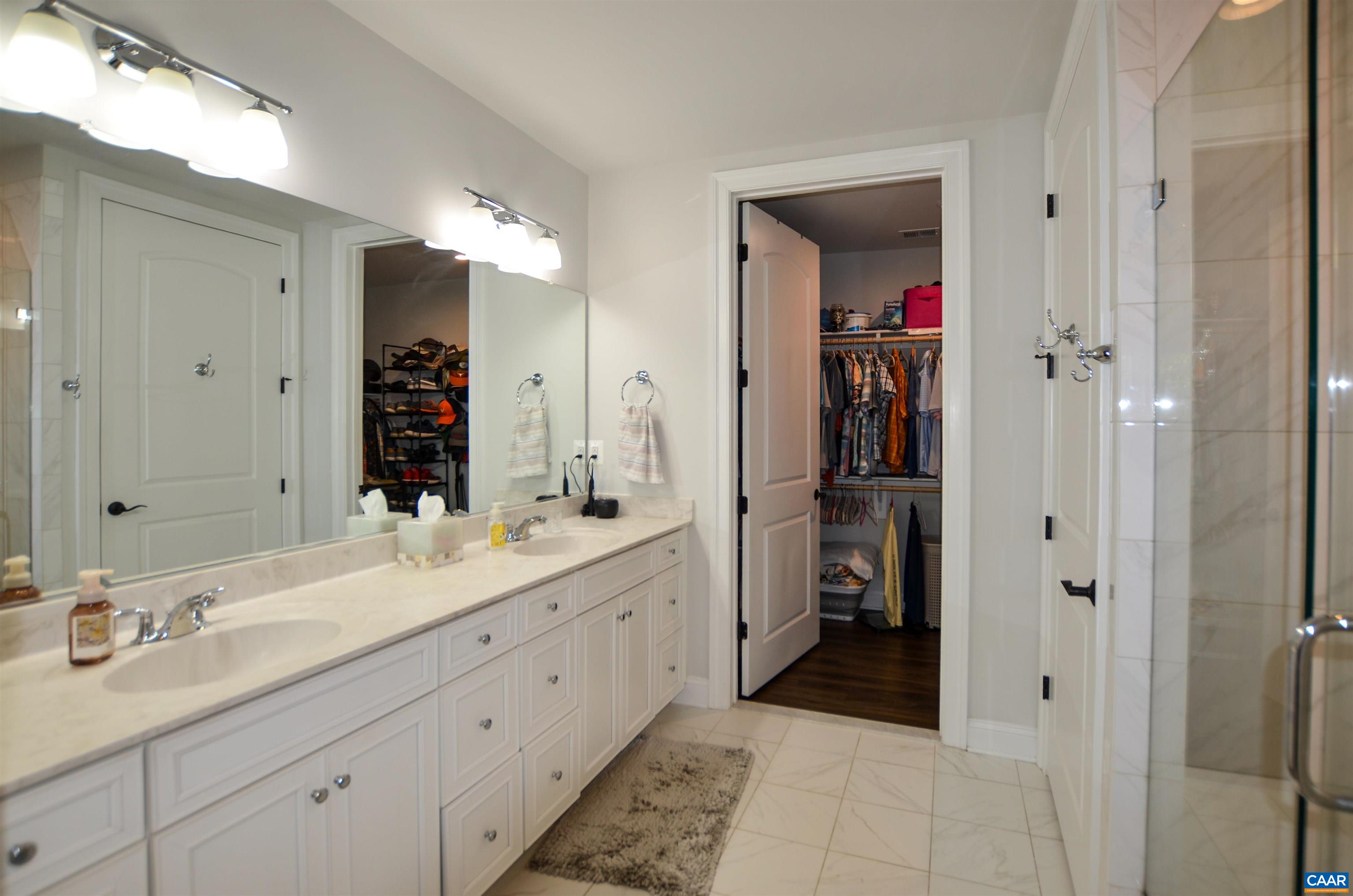 327 Claibourne Road Crozet, VA 22932 - Photo 21 of 36 a spacious bathroom with a double vanity sink and a mirror