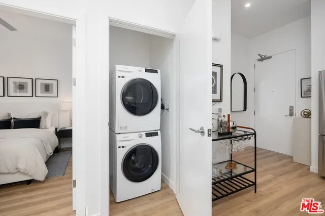 a view of a bedroom with washer and dryer