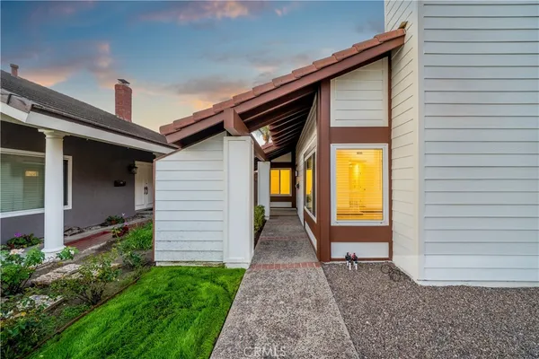 a front view of a house with a garden