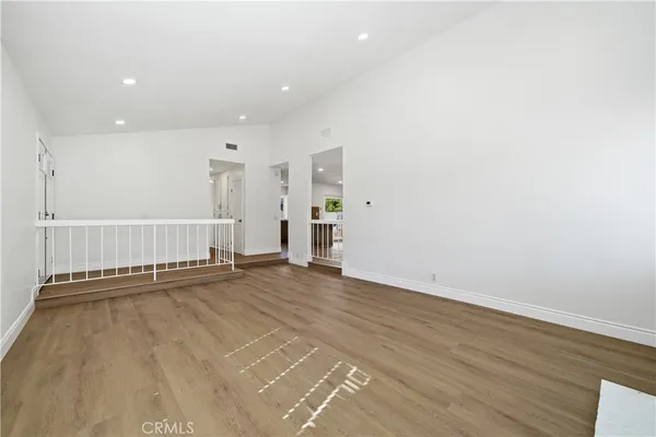 an empty room with wooden floor