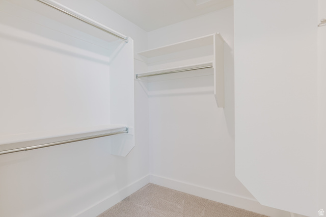 433 North 600 West Smithfield, UT 84335 - Photo 35 of 40 Walk-in closet featuring built-in shelving, two levels of hanging rods, and light-colored carpeting