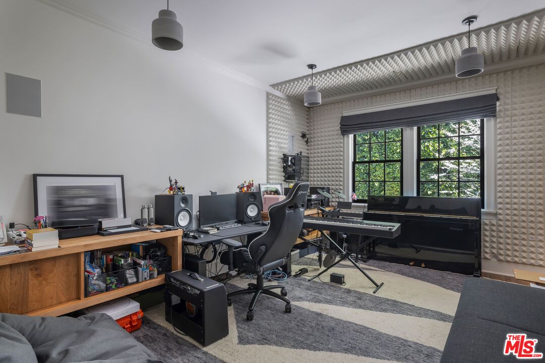 1701 Westridge Road Los Angeles, CA 90049 - Photo 12 of 36 a living room with furniture and a flat screen tv