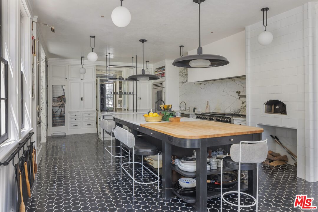 1701 Westridge Road Los Angeles, CA 90049 - Photo 15 of 36 a view of a dining room with furniture and wooden floor